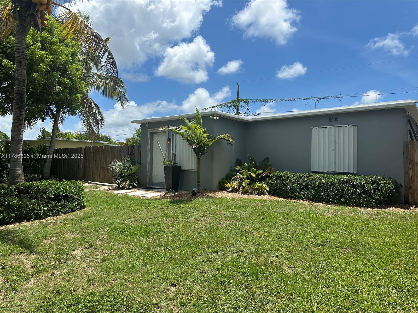 Buy with equity, priced to sell below appraised value. Fabulous home situated on a large private lot w/ plenty of room for all your toys, boat, RV or more. There is even a flex space for a home office/gym or add'l bedroom. The roomy layout & neat outdoor spaces will not disappoint. Enjoy your own backyard oasis, secluded from the street w/ a lush hedge & two entrances. Extra wide wood rolling gate for easy access. The custom tikis make you feel like you are on vacation & offer additional living space while the covered back porch is also convenient to BBQ or relax/unwind. The property is fenced w/ new grass sod, includes a storage shed, accordion shutters, concrete roof, central A/C, plenty of closets & laundry room. A turn-key single family home w/ updated kitchen/bath, priced to sell!