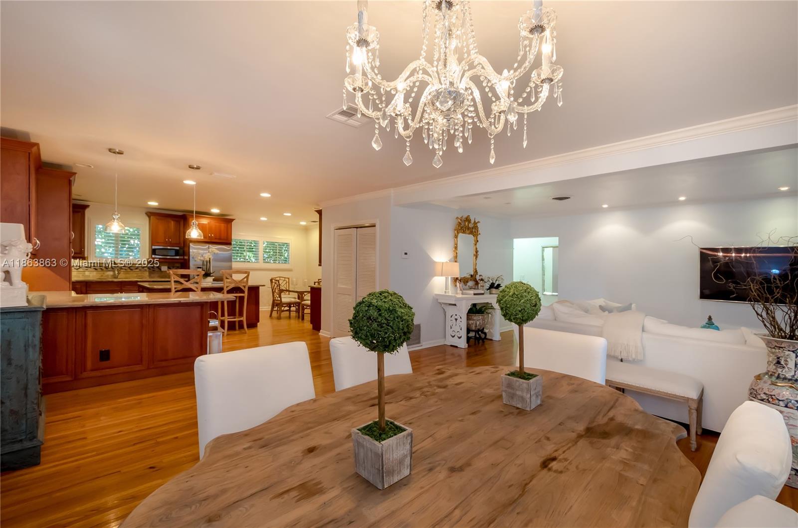 Elegantly understated and beautifully updated, this 3BD/2BA executive home is nestled on a quiet, tree-lined street in Coral Gables' coveted Italian Village. Designed with soft neutral tones and meticulous attention to detail, the home features gleaming hardwood floors, expansive impact windows and doors, and a bright open kitchen with breakfast nook. Both bathrooms have been tastefully renovated, and the spacious 2-car garage adds convenience. The open, airy layout is ideal for entertaining while maintaining a warm, welcoming atmosphere. A true turnkey gem in the heart of the Gables.