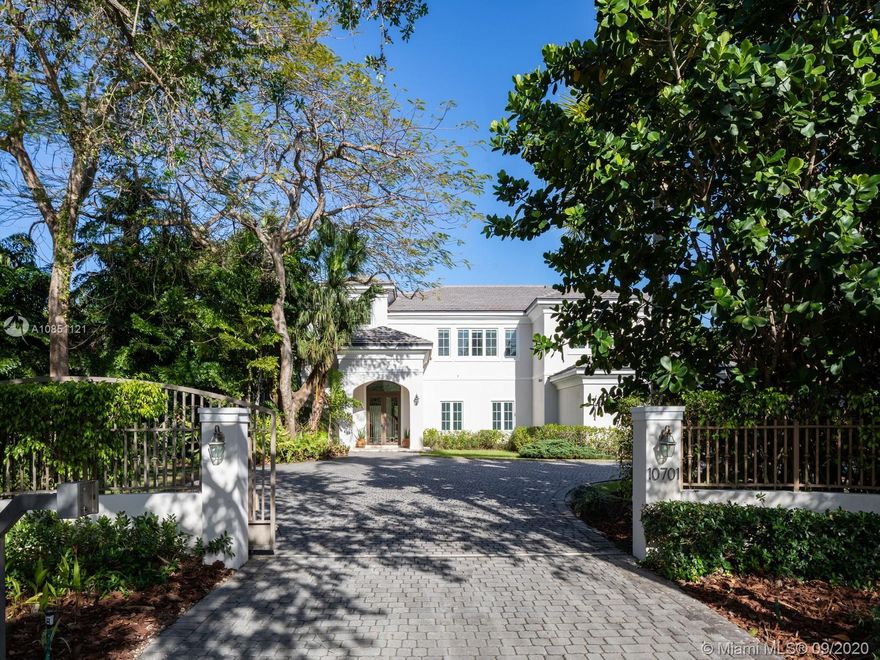 Elegant Transitional Estate in the heart of Pinecrest w/a modern flare, clean lines & neutral colors that provide light & warmth. Surrounded by lush foliage & resting on 40,075 gated spacious lot, this 6BD/6/2 BR home w/ upstairs den/office offers ample rm to entertain w/an expansive backyd, covered terr, swimming pool & private tennis court. Greeted by volume ceilings, this open flr plan creates great living areas, integrated family rm w/gourmet kit, built in appl, granite counters, breakfast nook & isolated dining rm for private family dinners. Oversized master ste w/private terr & spa like bath w/jacuzzi tub. Extra Feat: 1000-Gal Tank Gen, central vac system, 3 Car Gar, marble & wd flrs, imp. win/drs, Pinecrest & elite schls nearby.