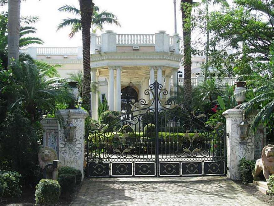 Mediterranean Palazzo with downtown Miami skyline views. This 11 000 SF house in gated Palm Island is full of details. Build in year 2000 in oversized 30 000 SF lot with 100 LF on the water with private dock. Double staircase entry, glass ceiling atrium,  two story high marble fireplace, hand painted ceilings, marble and wood columns, elevator, sauna, summer kitchen, rooftop area, maid's quarter, generator, lighting controls etc. New roof with warranty. All 9 A/C units renewed. House painted outside.