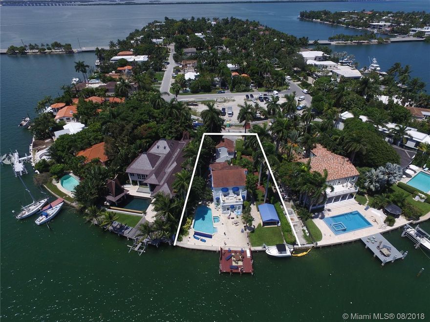 Situated on a pie shaped lot with 100 feet, 12,772 of direct Downtown exposure and south of 5th skyline views.  2 level Mediterranean revival recently modernized waterfront home on the Ventian Islands features 6 br/5.5 baths (includes two 1br/1ba detached guest house).  Spacious living & family areas, formal dining room, chef's kitchen with top appliances.