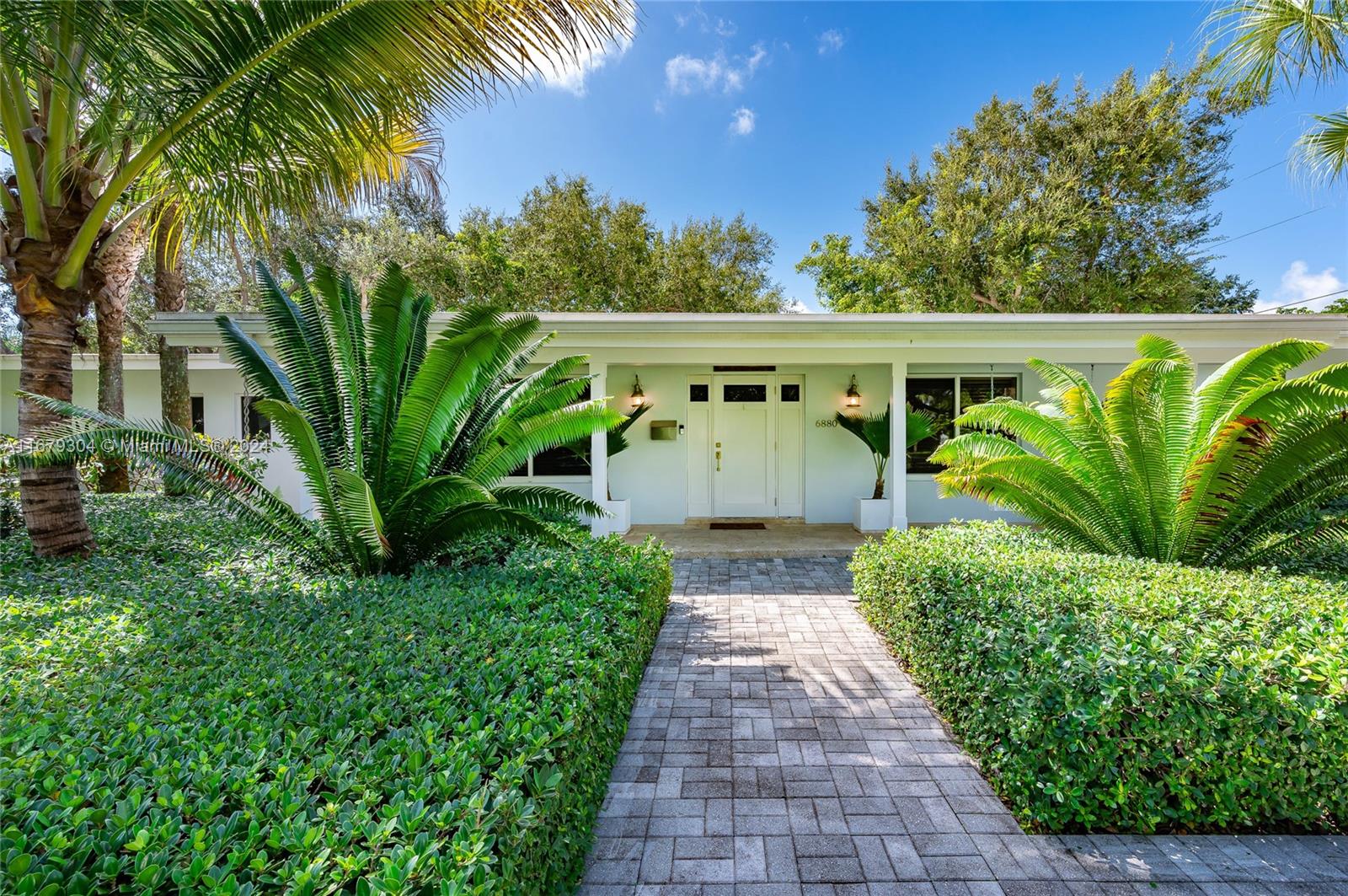 Step into this impressive 4 bedroom/3 bath home, perfectly situated in the heart of Pinecrest, within the most desired school district. Set on a generous half acre lot with lush backyard with mature trees. The outdoor Private sanctuary floods the home with an abundance of natural light. Floor plan boasts a Grand living area, with high ceilings and opens to an integrated eat-in kitchen and dining area & vast Home Office. Master suite includes large walk-in closet, updated bathroom and separate his/hers vanities & sinks. Spacious laundry and storage room lead to an ample garage. Additional features: impact windows, new AC, new plumbing, stainless appliances, paved areas on both sides for boat/RV parking, Hot tub, fire pit and plenty of room to build pool and/or separate guest quarters.