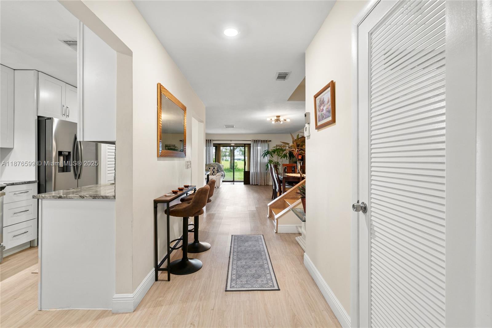 Beautifully updated 1,426 sqft two-story townhouse in the desirable Boca Lago. This centrally located residence welcomes you with a private walkway and sitting area surrounded by lush gardens and colorful flowers. Inside, the first floor offers a spacious living room, den/Florida room with serene backyard views, a modernized kitchen with pantry, stackable washer/dryer, and half bath. Upstairs features two large bedrooms and two full baths. Highlights include a new roof (2025), updated kitchen, ample storage, and an open layout filled with natural light. Residents of The Pines enjoy an active 55+ lifestyle with two exclusive pools, walking paths shared with Boca Flores, and access to other amenities. Service animal with documentation welcome if approved by board/association.