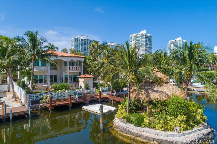 Truly an aquatic paradise, this incredibly elegant waterfront estate offers a magnificent 6,135 total SF 5bd/5.2ba floorplan situated on a 9,225 SF lot. 60ft of water frontage w/a 40ft dock + separate 2-jet ski slip overlooking the residence’s secluded private island. No fixed bridges to the bay or Ocean. Additional features include: grand atrium entrance, dramatic high-volume ceilings, designer finishes, detached guest suite, oversized impact windows/doors, elevator, 2 laundry rooms & chef’s open kitchen overlooking pool area. The regal double Master suites on the airy 2nd floor each offer gigantic walk-in closets, sitting areas, spa-like baths w/toto toilets & private terrace. 2-car garage, gym, & pool area w/cabana bathroom. Exclusive beach access from HOA for only $1 a day.