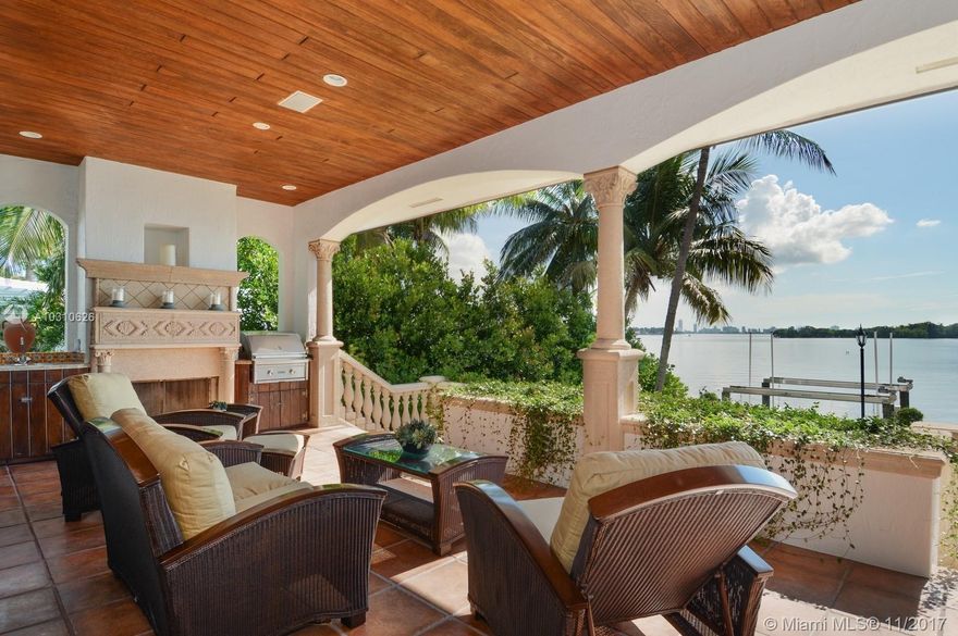 Richly imagined, precisely crafted, Italian Villa! Wide bay on guarded island. Radiant rooms w/volume ceilings. Plush home theater, connoisseurs wine vault. Huge chef kitchen & family rm. Formal dining + 2nd alfresco dining area w/ full outdoor kitchen. Generous bedrm suites. Huge master closet. Dock, davits, generator. Pool & Jacuzzi. 4 car garage. Bonus poured concrete full basement! Hushed, leafy neighborhood, close to world renowned Design District. Security Video/Audio Devices Operating on Premis