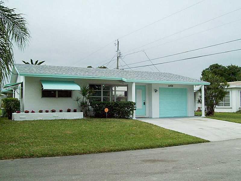 Move in ready 2/1 w/1 car garage w/remote opener. Just repainted inside & out. Community maintenance includes lawns & sprinklers. Roof replaced in 2013, A/C has warranty until 2018. House features beautiful laminate floors in bedrooms, living & dining roo m, remainder is tiled. Wheelchair accessible bathroom. Enclosed family room with pass thru to kitchen. The house is wired for video security & is generator ready. Generator included in the sale. Permitted extra wide driveway fits 2 cars. Water filter.