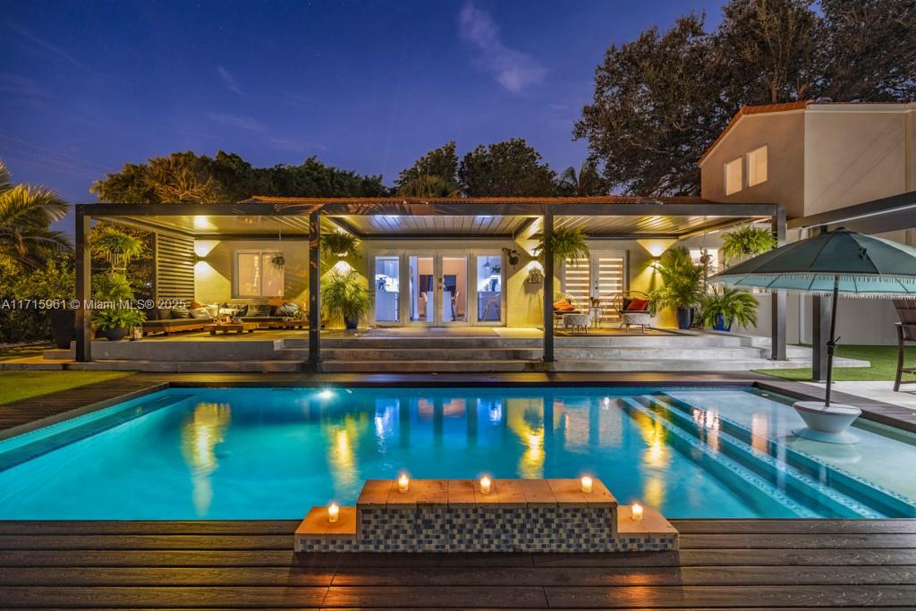 Tucked away on an oversized lot at the end of a quiet cul-de-sac, this 5-bedroom, 4-bathroom home exudes luxury and comfort. A new 800+ sq. ft. addition, completed in 2022, adds two spacious bedrooms and bathrooms, enhancing the home’s elegance. The expansive floor plan includes formal living and dining areas, a family room, and a versatile bonus room with an ensuite bath. The primary suite features a spa-inspired ensuite, while the chef’s kitchen impresses with premium appliances, gas cooking, and custom cabinetry. Outside, a resort-style backyard awaits with a tropical pool, new summer kitchen, automated pergola, and lush landscaping. The property offers gated rear and covered parking for convenience . This home blends modern with serene living. Non Flood Zone