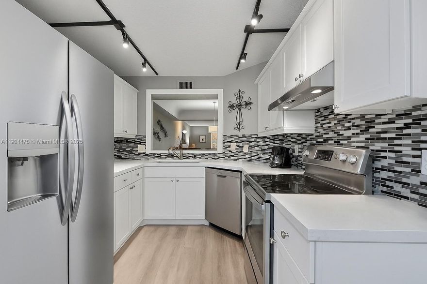 Wake up to spectacular golf course views every day in beautiful, 55+ Boca Barwood. Sip your morning coffee or unwind with afternoon tea from your enclosed sunroom, where extra sliders invite in the breeze or create a cozy extra room for relaxing or entertaining. This updated first-floor 2BR/2BA condo welcomes you with stylish modern furnishings, upgraded cabinets, vanities, lighting, and luxury vinyl flooring throughout. The full-size washer/dryer sit conveniently in the sunroom. The designated covered carport protects your car from the sun. Enjoy resort-style living with a pool, tennis, pickleball, and clubhouse— in this extremely well maintained community with LOW HOA fees, completed milestone inspection, and strong reserves. Just minutes to shopping, highways, and the beach!