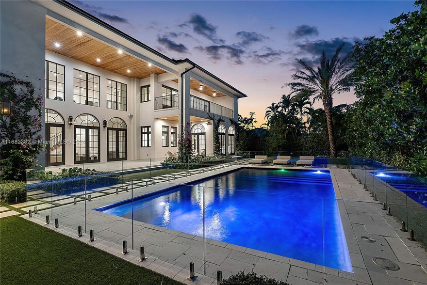 This one-of-a-kind Mediterranean waterfront haven boasts 6 bedrooms, 6.5 bathrooms, and 7,948 square feet of meticulously crafted living space by renowned interior designer, Ali Budd. With 112 feet of water frontage, this estate, along with its furniture, was uniquely designed to be both a piece of art and a family home. The dreamy kitchen is curated with Downsview cabinetry, Italian marble, and a La Cornue range. All bedrooms are oversized with walk-in closets. European wallpaper from exclusive brands like La Maison Pierre Frey and incredible hand-painted work of de Gourney adorn the walls. The exterior of the property was fully redesigned and features AstroTurf, a custom glass pool fence, all-new trees/hedges, and stainless steel trellises for the Bougainvilleas surrounding the property.