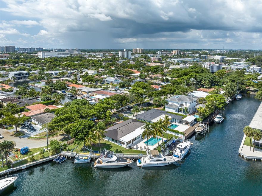 Set in the heart of South Florida, this extraordinary corner lot is one of the few that boasts 200 feet of direct dockage, offering breathtaking, unobstructed views. The seamless flow between indoor and outdoor spaces invites effortless entertaining, with a heated saltwater pool overlooking the serene waters. With expansive vistas and an enviable location, this home delivers the pinnacle of coastal living, just moments from pristine beaches and vibrant city life.