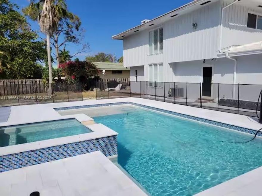 Stunning modern home featuring 5 bedrooms and 4 bathrooms, set on an oversized 13,000-square-foot lot in the heart of Deerfield Beach, just south of Boca Raton. This fully remodeled residence offers a brand-new pool and jacuzzi, a massive private backyard, and sleek porcelain flooring throughout. The gourmet kitchen is equipped with stainless steel appliances and designed for both style and functionality. Offered fully furnished—just bring your toothbrush—this turnkey home is move-in ready. Located just over 1.5 miles from the beach, Deerfield Beach is a dreamy coastal neighborhood known for its laid-back vibe and classic Old Florida beachfront charm, blending relaxed seaside living with easy access to dining, shopping, and entertainment. This is Florida living at its finest.