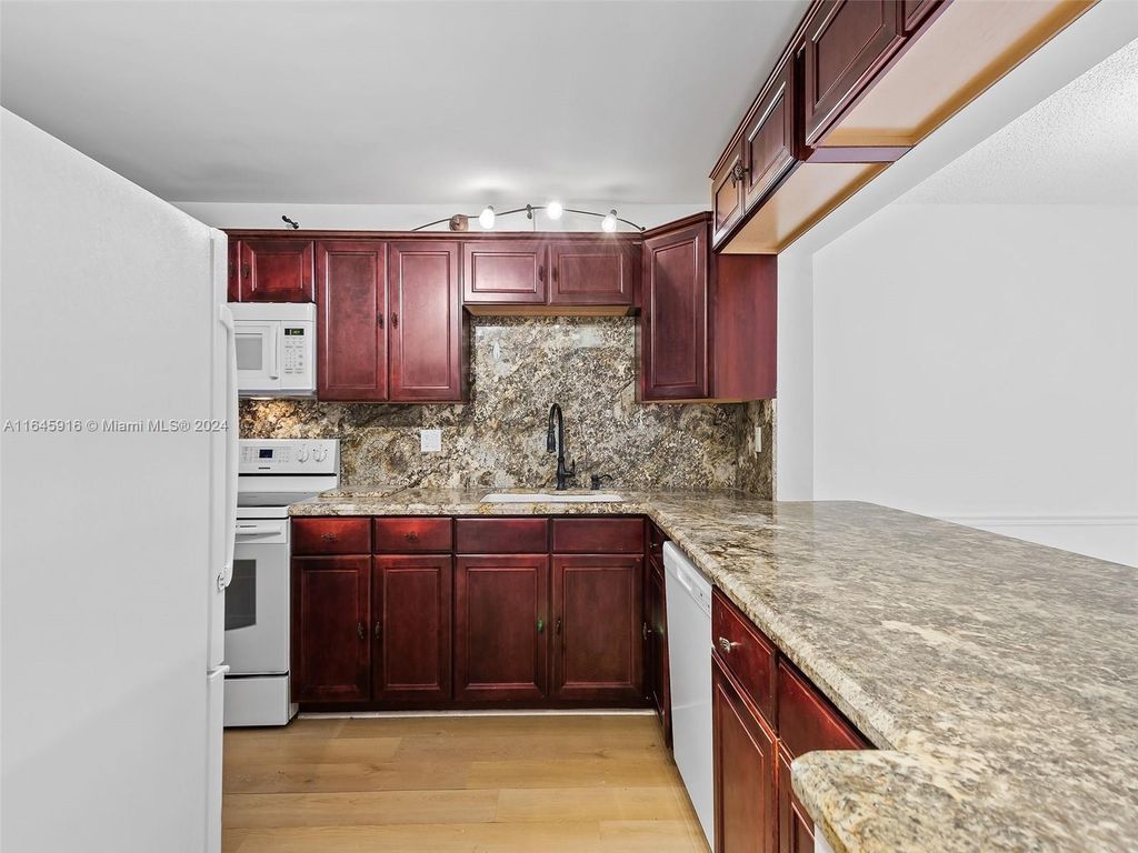 Photo of 2310 S Cypress Bend Dr #104, Pompano Beach, FL 33069 (MLS # A11645916)