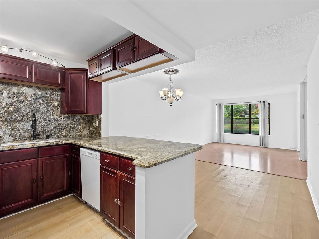 Photo of 2310 S Cypress Bend Dr #104, Pompano Beach, FL 33069 (MLS # A11645916)