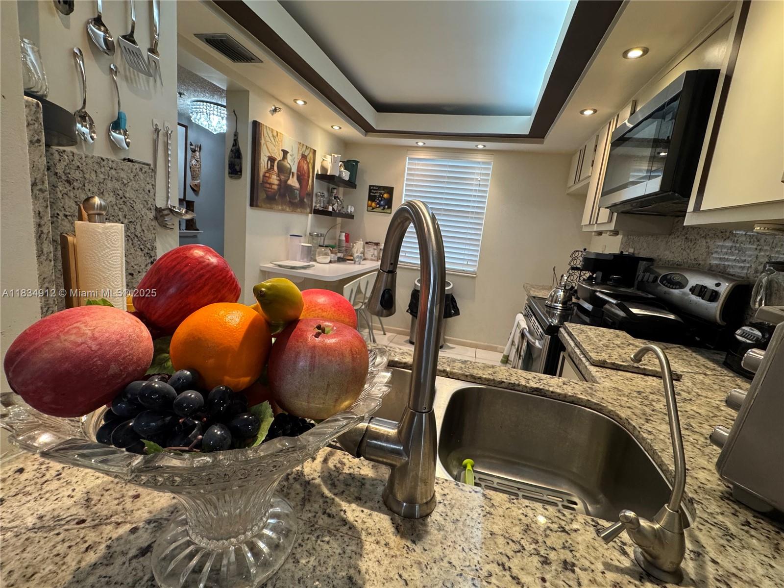 WOW! WHAT AN OPPORTUNITY! PRICED TO SELL NOW! Spacious 2-bedroom, 2-bath apartment offering a private view of lush green palms right from your terrace. Sold fully furnished—offers will be considered for purchasing the furniture separately. The unit features neutral tile flooring throughout, creating a fresh and welcoming atmosphere. Additional highlights include a washer and dryer inside the unit. Refrigerator is not included. Assigned parking space B 47. The association requires a 20% down payment with the offer, minimum 710 credit score, annual income of $45,000, and 6 months of maintenance fees held in escrow. This 55+ community includes water, cable TV, internet, pest control, building insurance, a 24-hour staffed gatehouse, tennis and pickleball courts, AND MORE! ON LBX