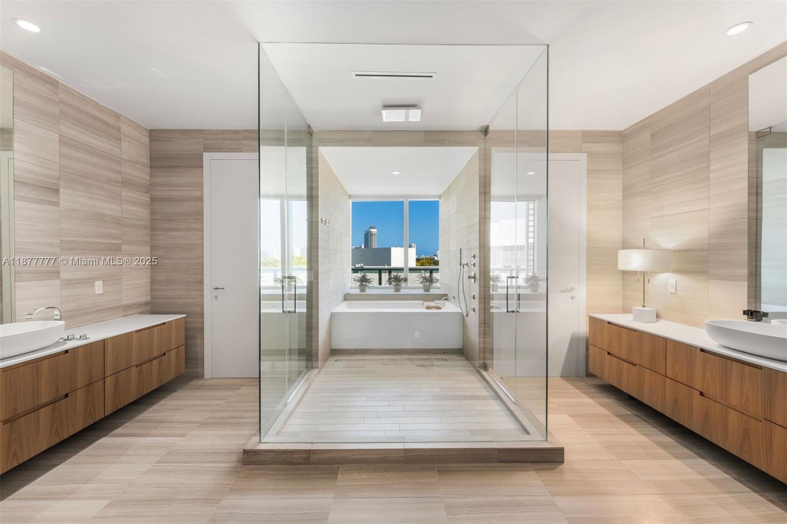 Welcome to an exceptionally rare 4bd, 4.5ba corner unit spanning 4,204 sq ft of refined indoor living. With a private elevator entrance, multiple entertaining areas, and a large media room, this residence feels like a private home. Breathtaking views of the Miami skyline through floor-to-ceiling windows, the expansive layout is ideal for both relaxed living and elevated entertaining. A sleek Boffi kitchen with Gaggenau appliances anchors the open living space, while custom millwork and clean architectural lines echo minimalist design. Oversized primary suite includes spa-inspired bath, 2 walk-in closets, private balcony. Enjoy 5-star Ritz-Carlton amenities with 24-hr concierge and valet service. This serene enclave just minutes from the beach, Sunset Harbour, and Bal Harbour.