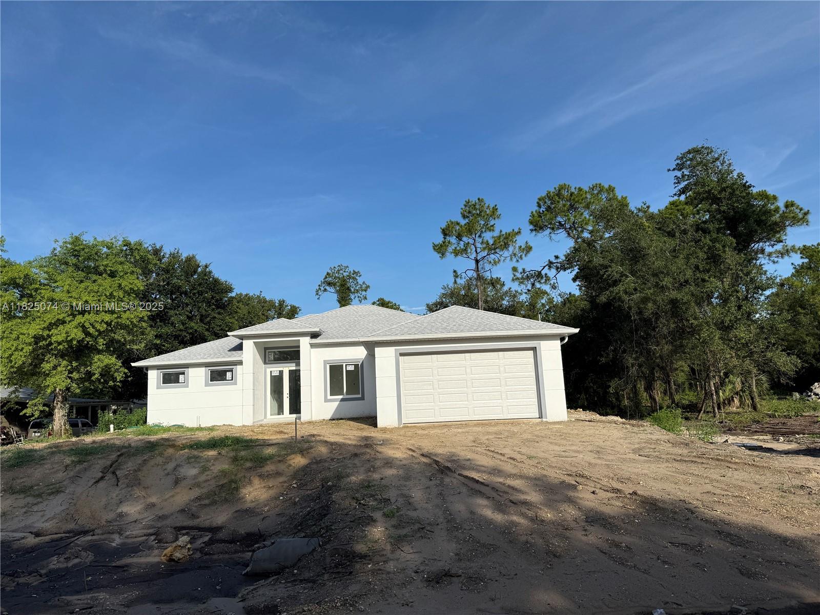 This newly built home offers. Modern design and functional living in a convenient growing community.
The floor plan includes four bedrooms, three bathrooms, with the primary suite featuring two walking closets. The kitchen is equipped with white cabinetry, and stainless-steel appliances, providing both style and efficiency. double oven, refrigerator, dishwasher. Porcelain tile 32x 32extends throughout the home, enhancing the spacious layout. High ceilings, double front impacts doors, and windows, and two-car garage. A covered lanai offers additional outdoor space. Must see.
