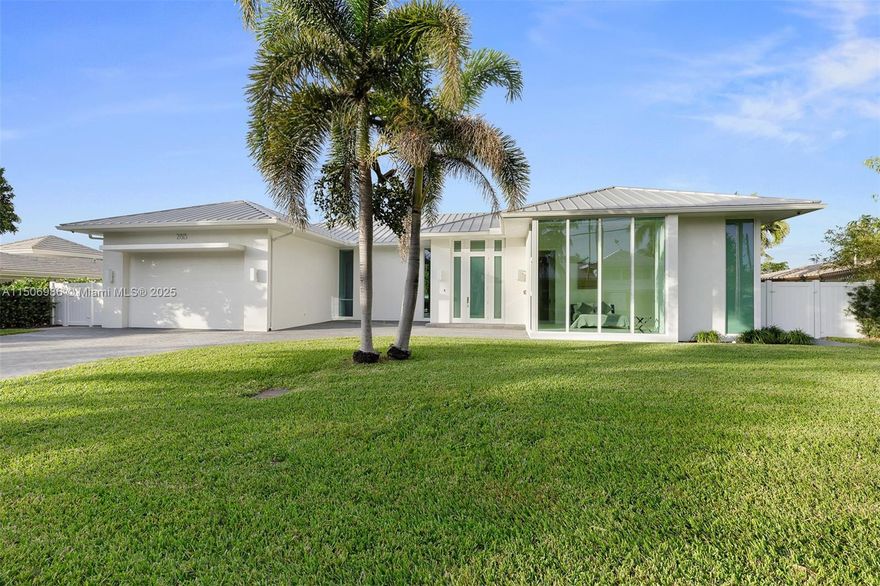 A MUST SEE. Indulge in waterfront luxury in Fort Lauderdale's Coral Ridge. Built in 2017, this gem seamlessly blends indoor and outdoor spaces with a huge covered patio ideal for gatherings. The 13 ft ceiling extends the living space outdoors, featuring a jacuzzi and a grilling area. Boaters will love the 100' waterfront dock, intracoastal access, boat lift, and a 52' saltwater lap pool. Gas powers amenities like the BlueStar stove, new AquaCal pool heat pump, outdoor fireplace, new AC system, and Cummins generator. Inside, find porcelain tiles, a kitchen island, and a spacious master suite with dual sinks, soaking tub, and separate shower. A metal roof ensures comfort. The third bedroom is now a wine room. With three separate areas to entertain, this is more than a home. No fixed bridges.