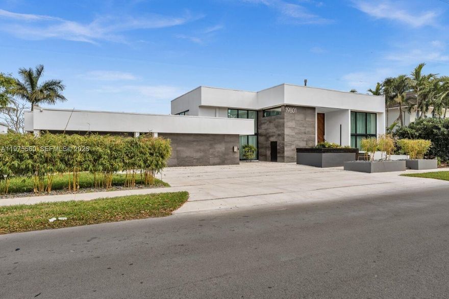 Rare opportunity to own a contemporary masterpiece by award-winning architect Danny Sorogon. Set on an 11,550 SF oversized lakefront lot with 110FT of waterfront plus a 1,300SF deck, this architectural showpiece features a 14FT High entry door, soaring ceilings, and walls of glass flooding luminous interiors with natural light. A dramatic entertaining layout includes an extraordinarily large chef’s kitchen with two islands, grand living and dining spaces, a glass-encased loft, and a spa-inspired primary suite with pool and lake views, as well as a resort-style pool, summer kitchen, and double jet ski dock. Located within the gated community of Enchanted Lake with no HOA, within walking distance to houses of worship, the JCC, beaches, Aventura Mall, major highways, and excellent schools.