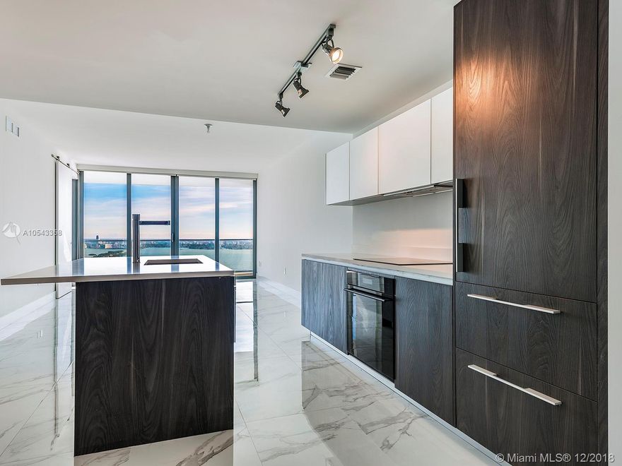 Welcome to ONE PARAISO, the best tower of the Paraiso District with direct views of BISCAYNE BAY and ocean. Unit 4002 features 1124 SQFT of living area, 1 Master Suite + DEN and 1.5 bathrooms. Ample space for entertaining and extensive balcony featuring the most amazing views that Miami can offer. Unit has been finished with beautiful ceramic floors, blackout in master bedroom and screen in living area, and brand new California closets. Enjoy the best amenities at Paraíso District with gym and spa facing the bay, 3 pools, tennis courts, and more. Call Listing agent for showings and information.