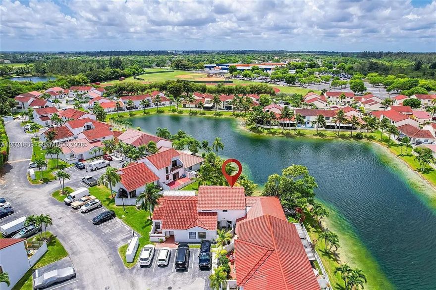 Beautiful lakefront townhouse offering style, comfort, and breathtaking views! This fully renovated 3-bedroom, 2-bath residence features a modern open feel with a remodeled kitchen, stainless steel appliances, updated bathrooms, and a striking metal staircase that adds contemporary character. Conveniently designed with one bedroom and a full bath on the first floor. Wake up to stunning sunrise views over the lake from the private balcony off the primary bedroom. Enjoy year-round outdoor living on the peaceful patio overlooking the water. Residents also have access to the community pool. Ideally located near shopping, dining, hospitals, and just a short drive to the Florida Keys. A rare opportunity to own a beautiful waterfront home in a highly desirable community!