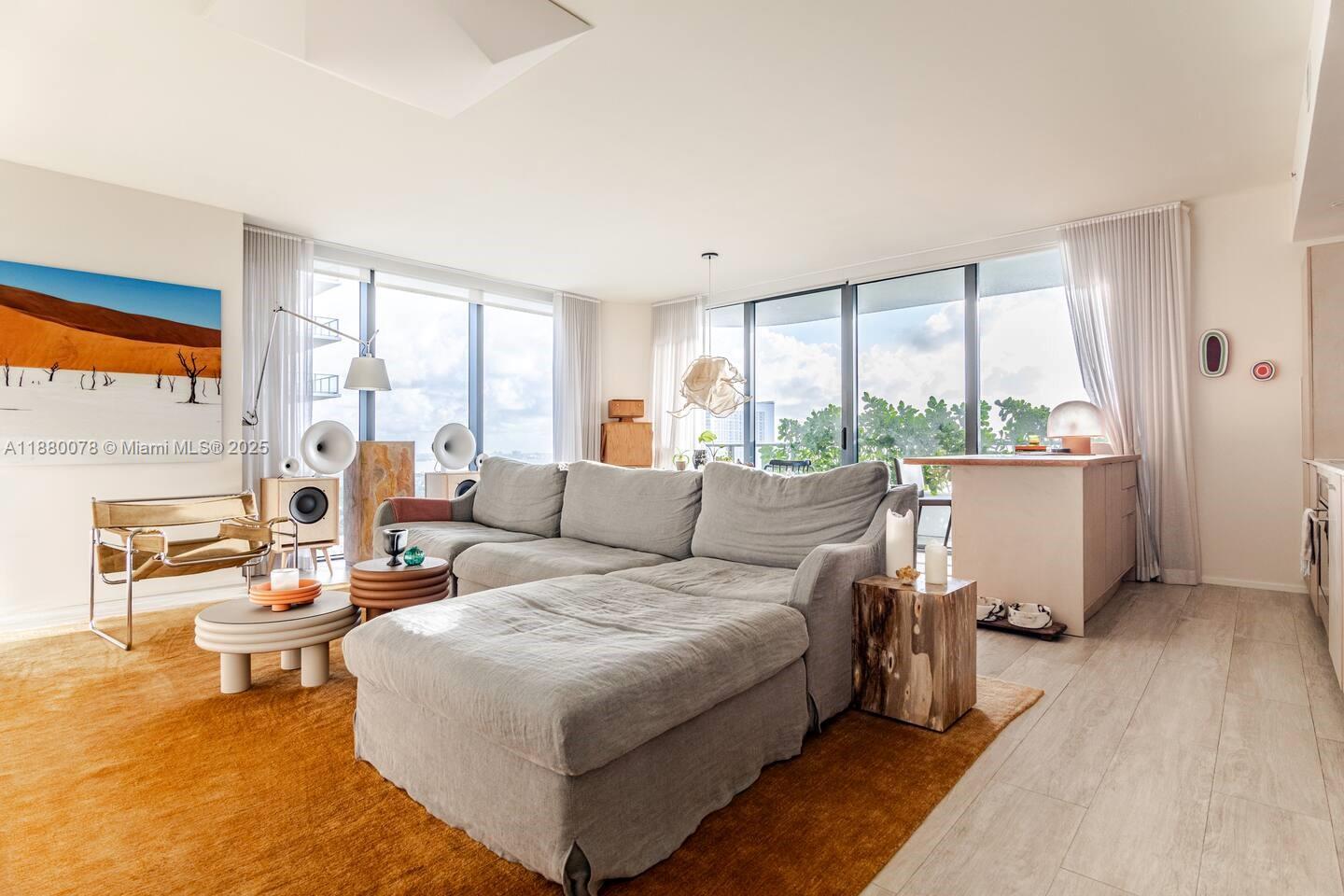 One-of-a-Kind Corner Unit with water views at Hyde Midtown. Unobstructed Biscayne Bay views in this fully renovated high-floor 3 bed / 4 bath 1,435 sq ft—floor-to-ceiling windows, corner unit at Hyde Midtown. Custom designer finishes with Italian Mireri Monticelli lighting, polished nickel and brass bathroom fixtures, built-out California Closets, and new doors. Each bath is finished in sleek microcement. The open-concept kitchen and living space with custom cabinetry, a burlwood-topped island, and direct access to your oversized balcony with bistro seating, lounge chairs, and travertine shelving, perfect for indoor/outdoor living. The main suite offers two closets, a spa-inspired bath, dual vanities, & an oversized shower. Comes with 2 deeded parking spots & a private storage unit.