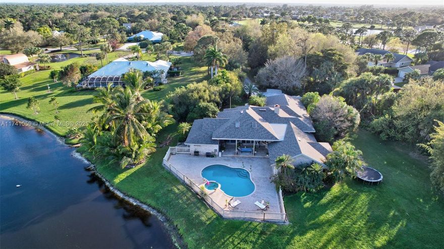 Lakefront home in an exclusive private community of Lakeridge with only 10 homes. Bright & light open living spaces feature vaulted ceilings, stone flooring, custom millwork, a coral rock fireplace, and breathtaking water views throughout. This home has 3 bedrooms, 3 bathrooms, formal dining room, and family rooms. The spacious open custom kitchen has wood cabinetry, granite countertops, a cooking island, breakfast area, and barstool counter seating. The large primary suite opens to the pool and includes a bath with a walk-in shower and soaking tub. Enjoy resort-style outdoor living on the covered terrace overlooking the lush grounds (1.25-acre lot), pool with spa, and lake views. New: roof, pool pump, washer/dryer. A/C is 5 years old. Close to shopping, dining, and downtown.