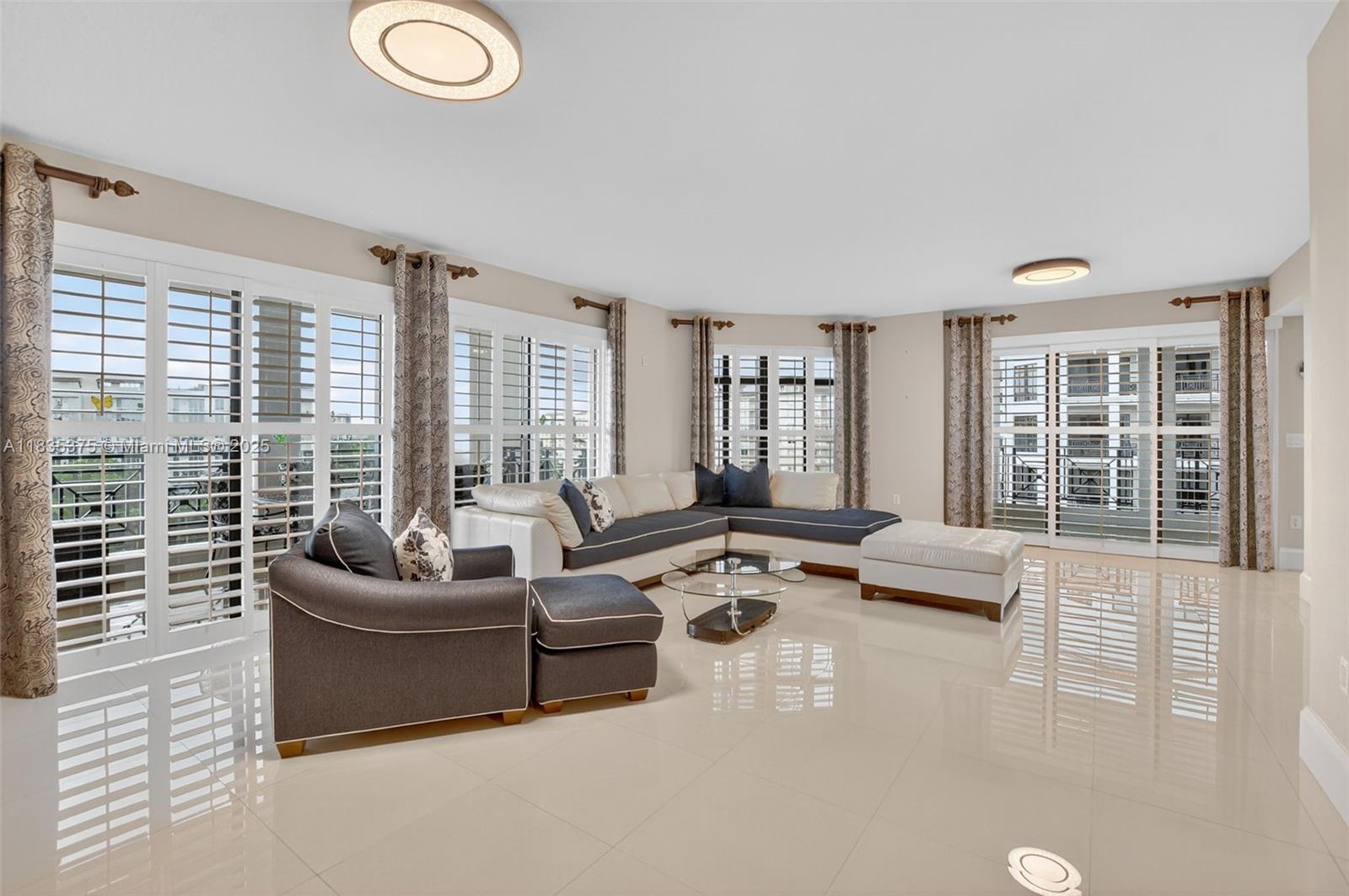 Spacious 3BR/3.5BA condo for sale at 200 East in Boca Raton. Features include an oversized living room, eat-in kitchen, dining area, and two balconies?one with golf course and peak of ocean, the other overlooking the pool. The primary suite offers balcony access and dual closets. Each bedroom has an ensuite bath plus a powder room. Extras: laundry room, custom media console with wine fridge, upgraded lighting, plantation shutters, and large white tile floors. Enjoy luxury amenities and a prime location near shops and dining.
