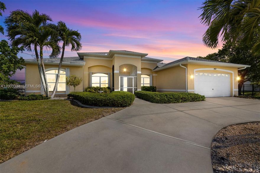 Welcome to your private slice of Southwest Florida living, where space, comfort and lifestyle come together seamlessly. Set on a rare triple lot, this property offers exceptional room to spread out, an increasingly hard to find opportunity. A circular driveway creates a strong first impression while providing ample parking for guests. Inside, a spacious open concept layout features a light filled great room, a versatile den or home office and a formal dining area designed for everyday living and entertaining. At the center of the home is a well appointed  kitchen with granite countertops, newer appliances and abundant workspace. A bay window breakfast nook overlooks the outdoor area, while expansive sliding glass doors fill the home with light and create easy indoor outdoor flow. The split bedroom floor plan offers privacy and flexibility with 4 bedrooms + a den that can serve as a 5th bedroom. Step outside to a standout feature, a huge resort style pool ideal for swimming laps, surrounded by an expansive patio with plenty of space to relax or entertain. The fenced backyard and concrete dock add both privacy and function. Additional upgrades include accordion hurricane shutters, a whole home surge protector, reverse osmosis water system and a 2021 roof. Conveniently located near dining, shopping, boating and Southwest Florida’s white sand beaches, this move in ready home offers a rare combination of space, upgrades and true Florida living, schedule your private showing today.