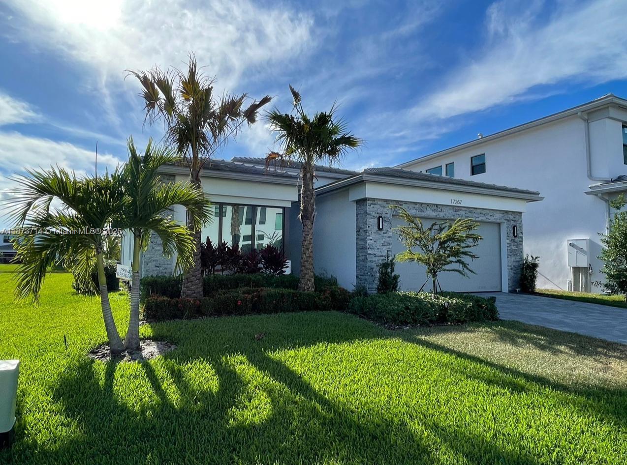 Furnished Annual Rent: $9,900. For a shorter 9-month lease: $10,200 per month. Located in the prestigious LOTUS gated community, with exclusive access to the community’s luxurious, resort-style amenities(gym, tennis courts, pool, pilates studio, playground, indoor playroom, restaurant, & special adult & kids activities available.) just a short walk away. Sleek contemporary home offers 3 bedrooms, 3 bathrooms, an Office/Den, and 2-car garage. Fully equipped European-style kitchen with all essential dishes, silverware, pots, glassware and pans. Lake views from the living room, as well as the master bedroom. Featuring tile flooring throughout out the home. Available starting November 13th, 2026
