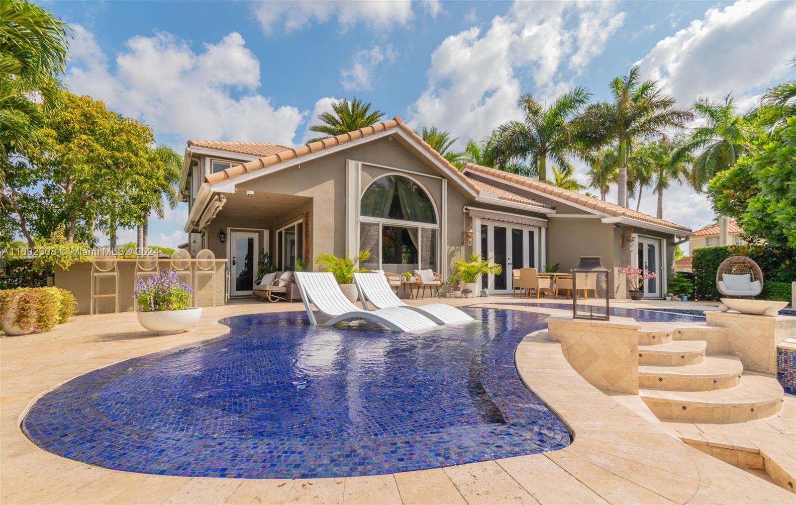 Welcome to the crown jewel of Silver Lakes! Nestled on a private, lakefront corner lot, this magnificent 4b/2.5b home sits on more than ¼ acre. Majestic front doors invite you into formal living & dining areas with lakefront views. Primary bedroom on ground level with custom closets, vaulted ceilings, French doors & sweeping views of outdoor paradise. Fully-equipped chef’s kitchen. Adjacent bunker room with LED fireplace & magnetic locking door. Entertainer’s paradise with 3-tiered heated salt-water pool. Custom-made tree shower, travertine deck & outdoor kitchen & bar. Fire bowls & lanterns, travertine bench & ample space for al-fresco dining. Lush landscaping & smart home features throughout. Security system & impact windows & doors. LIVING AREA IS ABOUT 2,800sqft Property FULLY updated.
