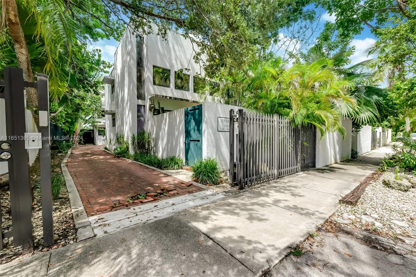 Experience abundant natural light & soaring ceilings in this renovated 3-bed, 3-bath townhouse in Bamboo Grove, a charming gated community just steps from CocoWalk's vibrant boutiques & eateries. Skylights & expansive sliding doors lead to a serene backyard oasis —perfect for outdoor relaxation & entertaining. The open-concept kitchen is ideal for modern living. The staircase guides you to a mezzanine bonus space—perfect as an office or media room—and two en-suite bedrooms with spacious walk-in closets. A 3rd bedroom on the first floor offers added convenience. Enjoy urban living with low fees, impact glass & two covered spaces. Impressive 23+ ft ceilings & a vast yard, plenty big for a lap pool. Embrace privacy & tranquility while being close to parks and the activity of Coconut Grove!