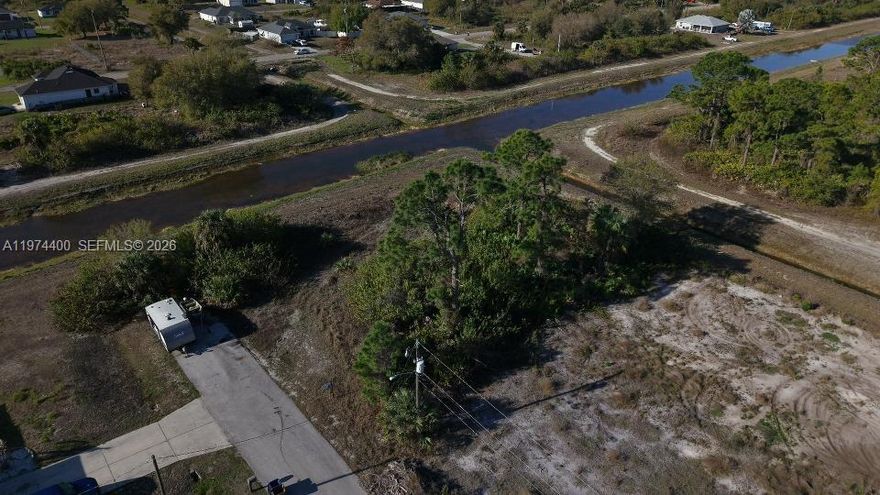 Beautiful vacant lot in fast-growing Lehigh Acres with canal views at both the rear and the side, offering rare privacy and serene water vistas. Located on a quiet dead-end road and just minutes from River Hall Country Club & Golf, with convenient access to Fort Myers at just 18 miles and 22 miles to LaBelle. This is an ideal setting to build your dream home in a rapidly developing area surrounded by new construction and Florida’s natural beauty.