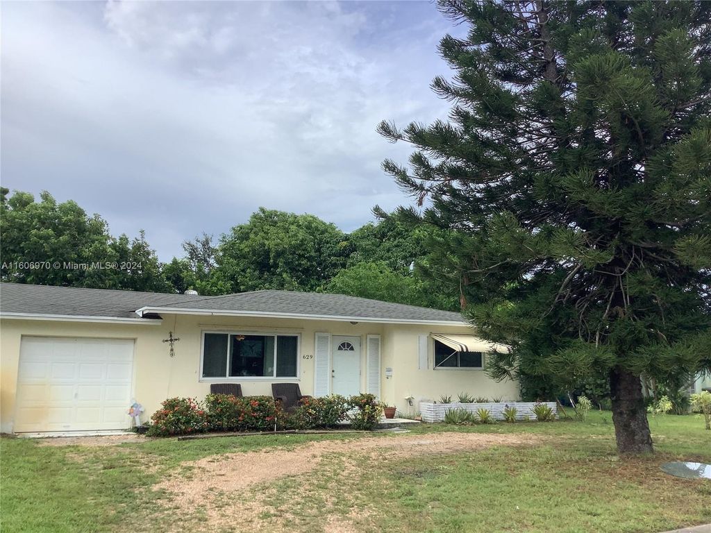 Photo of 629 Greenbriar Dr, Lake Park, FL 33403 (MLS # A11606970)