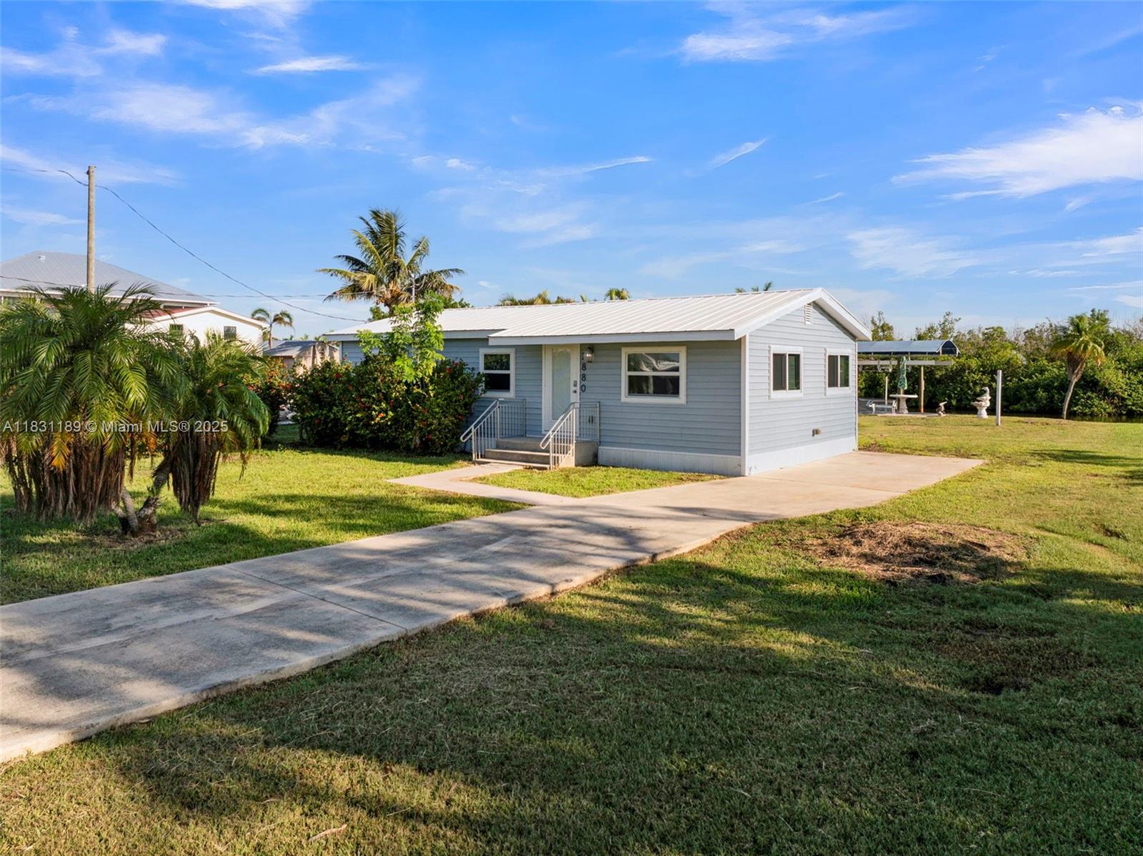 Tucked away on the south end of Pine Island in St. James City, this 2-bedroom, 1-bath waterfront cottage offers direct Gulf access on a wide, deep-water canal—no bridges, just open water to Matlacha Pass and beyond. Enjoy peaceful basin and mangrove views from the spacious backyard and dock, complete with a boat lift with aluminum cradle and new boat lift fabric cover. Set on an oversized lot with room for a pool, this property blends island charm with boating convenience. The cozy interior invites personal touches, while the location—just minutes from local shops, marinas, and restaurants—makes it ideal as a full-time home, vacation escape, or rental investment. No HOA.