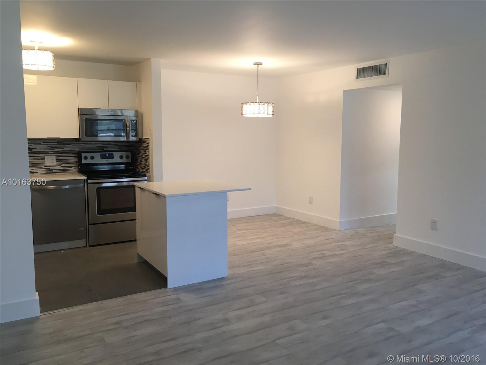 WON'T LAST, Beautifully remodeled unit with luxury details. Tile and Wood Floors, all NEW whirlpool appliances, kitchen with island, brand new bathroom with high end cabinetry and faucets. New lighting, new water heater and new A/C compressor. Large enclosed patio! Washer and Dryer in unit. No detail overlooked, move right in!! Unit can be rented after 4 years of ownership. Easy to show. Use show assist.