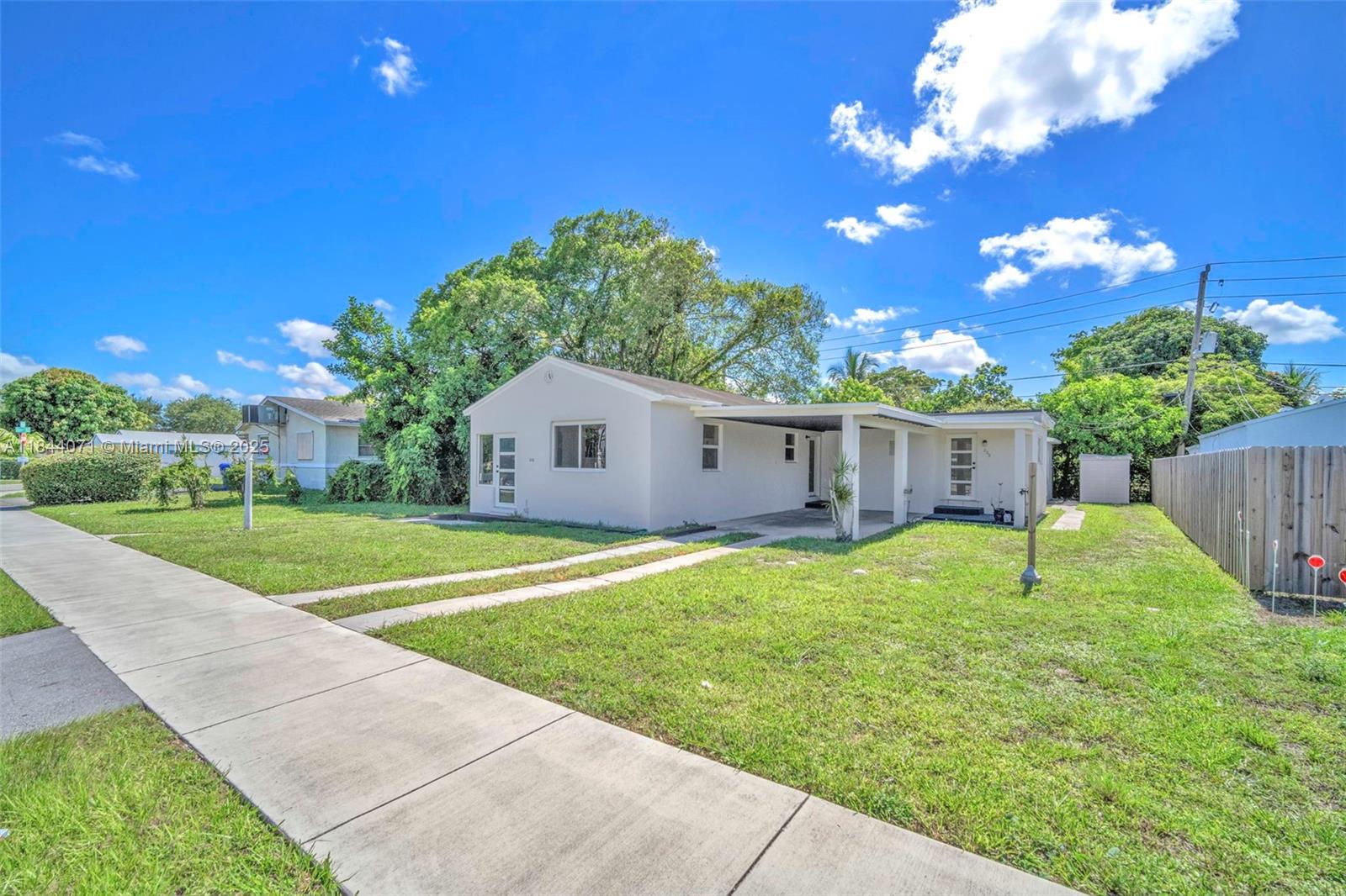 Charming 2/2 Home Near Downtown Hollywood! Beautifully remodeled w/the flexibility to live as a true single-family or split into two separate units, ideal for rental income or multigenerational living. The front of the home has been fully updated and features LED lighting, laminate wood flooring, new AC, a spacious living room, Florida room, bedroom, full bath with walk-in shower, and updated kitchen with stainless steel appliances & granite countertops. The back unit is a private-entry studio with its own kitchen, bathroom, and new mini-split AC. Additional highlights include all new impact windows and doors, fresh interior and exterior paint, a detached concrete laundry/storage room, sheds, and a covered carport. Just minutes from Hollywood Beach and the Boardwalk! Must see today!