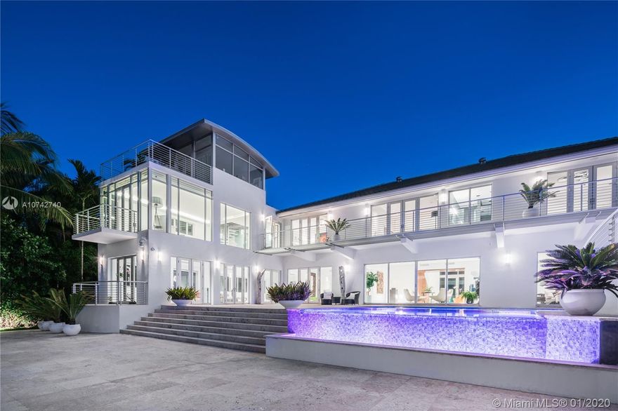 Entertain on a grand scale at this estate on Miami Beach’s idyllic Sunset Island II. Your guests will indulge in sweeping bay views from almost every gallery-like room. Impress them as they overlook your elaborate pool or private dock; perfect for your yacht. Or retreat to your two-level master suite, a personal oasis with its own tower and three private balconies. Eight bedrooms can accommodate a large family and staff, while the pool house, nestled behind the waterfall, is perfect for that honored guest. The home was recently fully renovated, to update it with all the amenities expected of luxurious contemporary life, such as a whole-home automation and audio system, while preserving its architecturally significant features and magnificently dramatic moments.