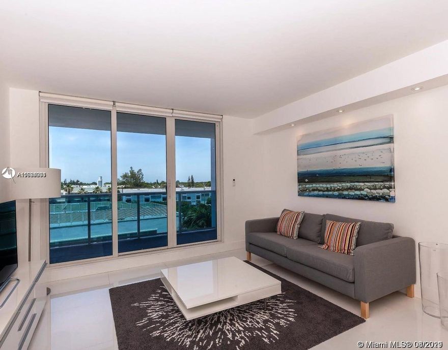 Beautiful Apartment located in one of the best buildings in Miami beach with beach access. Unit totally Remodeled and Tastefully decorated. It has a spacious living and dining room, open kitchen, Bosch appliances, & wine fridge. Bedroom with large closet & office space w/desk. Den is converted into a guest room. Glass porcelain tile floors, impact glass windows, auto shades. Enjoy sunset views from the balcony & all luxurious amenities offered by 1 Hotel & Roney Palace: 3 pools, luxury dining & more. Move-in ready! Direct access to the beach.