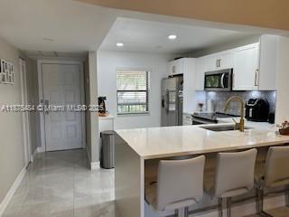 Beautiful 2/2 condo, fully renovated with porcelain tile on the living areas, laminate floor on Bedrooms, Open Concept Kitchen with Quartz Counter-top, customized guest closed with lots of space. The open living room facing the lake bring a beautiful view, with stunning sunsets all year long. Vaulted ceiling and neutral wall color bring the elegant touch to that unit, Attic for extra storage space. located on the desirable condominium of Boca Glades, in the hearth of Boca Raton. Close to Up two Boca, shopping and restaurants, 1/2 mile from Florida's Turnipike, this is a must see, bring your clients.