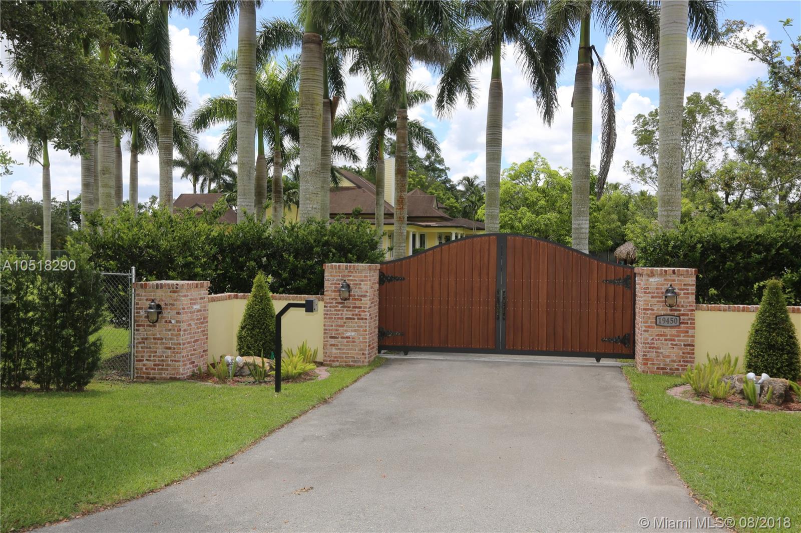 3 acres of prime fully fenced 3 acres of Homestead real estate. Huge wraparound verandas add a unique touch to this 2002 grand home. Main house features 4 bedrooms and 3.5 baths under a spacious floor plan of 6,005 adjusted s/f. Travertine marble floors, impact windows and doors, wood truss detailed ceilings, picture windows and high ceilings and top of the line fixtures throughout. New kitchen with breakfast nook, granite countertops, stainless steel appliances, and new oven and microwave combo. 1,000 gallon propane gas tank. New washer and dryer, Remodeled office and office bathroom. 2 separate guest houses - 1 bedroom and 1.5 baths each. State of the art remolded Horse stables, paddock, chicken coop/aviary, and archery range. Tiki hut (rethatched 2 months ago) and barbeque area.