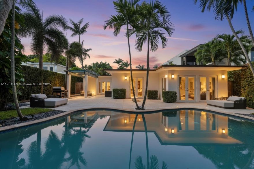 Nestled on a lush 12,000SF Lot along prestigious North Bay Road, this elegant 5-Bed, 3.5-Bath single-story residence combines modern sophistication with timeless charm. Bright & open interior features floor-to-ceiling windows, glossy porcelain floors, and living areas ideal for entertaining. A sleek modern kitchen showcases high-end appliances and custom cabinetry, while the formal dining room doubles as an art showcase. Enjoy a built-in bar, media room, and seamless flow to the private outdoor oasis with a heated pool and tropical landscaping. Additional highlights include a double garage, water filtration system, Generac generator and security system. This home offers the ideal balance of comfort, design, and functionality. Moments from the best of the ocean and La Gorce Country Club.