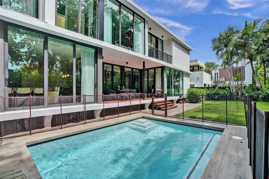 Walls of glass bathe this striking residence in natural light blending indoors & out with views of lush grounds, covered patio & pool. Conceived by award-winning Brillhart Architecture & featured in Architectural Digest. No expense spared by owner for their vision showcasing bespoke interiors by Mr. Alex Tate Design. Primary suite with private balcony & primary bath with dual head shower & hand carved sinks plus 2 additional ensuite bedrooms are upstairs. 4th independent ensuite bedroom is downstairs. Highlights include chef’s kitchen with Wolf, Sub-Zero & Blue Star appliances, standalone coffee station, striking IPE staircase & smart home features. Located on a quiet corner with low traffic enclave just 250 feet from the lush Banyan trees of Merry Christmas Park accessible by private gate