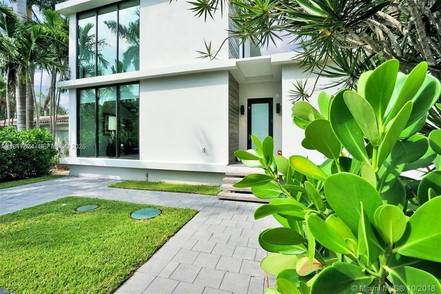 Walls of glass bathe this striking residence in natural light blending indoors & out with views of lush grounds, covered patio & pool. Conceived by award-winning Brillhart Architecture & featured in Architectural Digest. No expense spared by owner for their vision showcasing bespoke interiors by Mr. Alex Tate Design. Primary suite with private balcony & primary bath with dual head shower & hand carved sinks plus 2 additional ensuite bedrooms are upstairs. 4th independent ensuite bedroom is downstairs. Highlights include chef’s kitchen with Wolf, Sub-Zero & Blue Star appliances, standalone coffee station, striking IPE staircase & smart home features. Located on a quiet corner with low traffic enclave just 250 feet from the lush Banyan trees of Merry Christmas Park accessible by private gate