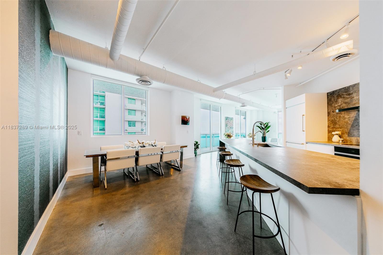 Discover the exquisite Star Lofts Residence 2003, nestled in the vibrant Edgewater neighborhood of Miami. Step onto the impressive wrap-around balcony where nearly 1k SqFt of unobstructed panoramic views of the Biscayne Bay, Atlantic Ocean, and the Miami skyline. Inside, you’ll find a spacious and inviting open floor plan, an oversized kitchen and an expansive main bedroom suite. Its loft-styled design boasts 10-foot ceilings, exposed AC ducts & conduits. Star Lofts is a charming boutique building w/only three units per floor, It is also exceptionally pet-friendly, complete with its very own dog park on the 7th floor. Other amenities that Star Lofts has to offer, including a newly renovated infinity-edge pool, an elegant lobby, a fully equipped gym, and convenient storage and bike rooms.