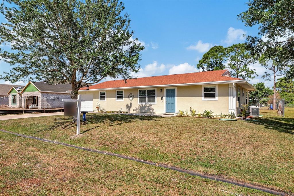 Photo of 431 SW Peach St, Port Saint Lucie, FL 34983 (MLS # A11583110)