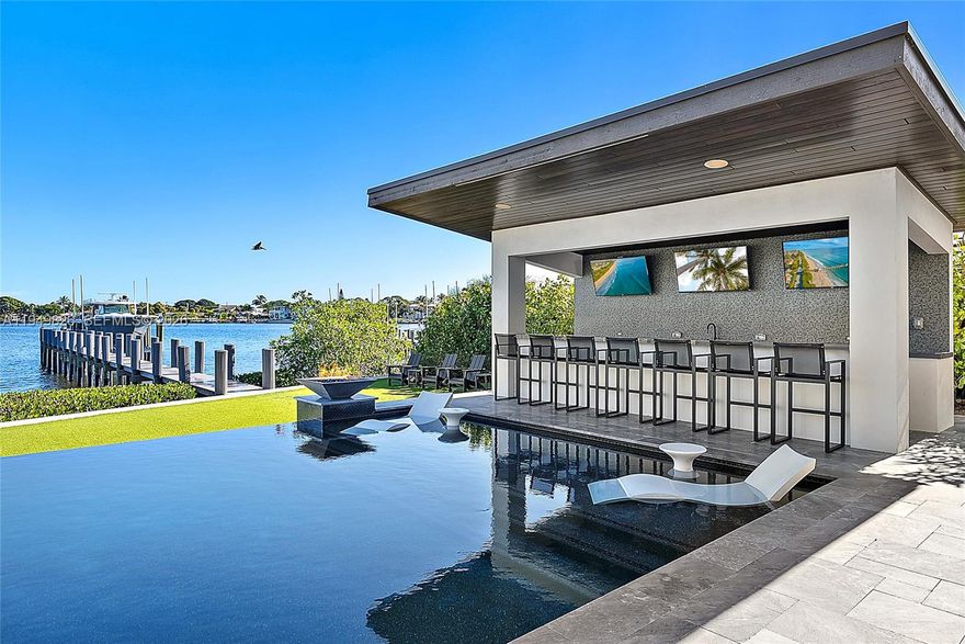 Waterfront estate home built in 2022, ideally positioned on a quiet street with fewer than ten homes and offering some of the most impressive views Jupiter has to offer. Designed with sleek, modern architecture, the residence is complemented by a separate guest house, providing flexibility for visitors, extended family, or a private office. Enjoy true waterfront living with a 50,000-lb boat lift and direct ocean access right from the backyard. Perfectly situated near Jupiter's iconic sandbars, waterfront restaurants, and everything the area's famous waterways have to offer. The outdoor living space is designed for year-round enjoyment, featuring a resort-style pool and spa, expansive turf areas, multiple fire pits, and an exceptional summer kitchen with a gazebo—creating the