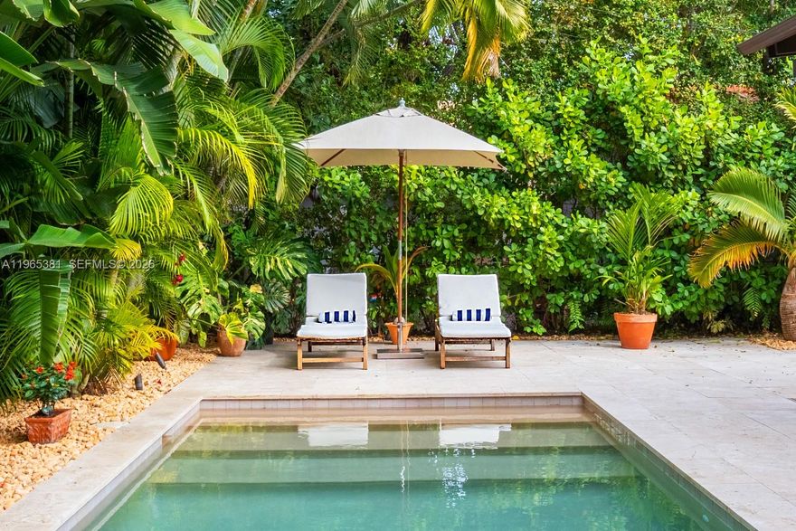 A rare jewel, this exceptional home delivers a true resort-style lifestyle rarely found in Miami. Thoughtfully curated for year-round enjoyment, the entire backyard was reimagined in 2023 into a private retreat featuring a heated saltwater pool with separate spa, with custom aggregate finish, Moroccan tile, refined stonework, lush palm landscaping, and dramatic night lighting. A pergola, summer kitchen, and covered porch create multiple outdoor living and entertaining zones—offering the kind of effortless indoor-outdoor lifestyle typically reserved for luxury resorts. Beyond the setting, the home offers meaningful, high-value improvements that elevate comfort and peace of mind. The property sits on naturally high elevation-no flood zone-with a dedicated drainage system. Inside, ceilings are higher than typical for homes of this era, complemented by a thoughtfully remodeled interior, modern linear slot diffusers air vents, and zoned comfort with supplemental mini-split AC units. Additional upgrades include a 2015 roof, 100% impact windows, impact front door and patio slider, upgraded electrical panel with surge protection, improved plumbing, resealed driveway, reverse-osmosis kitchen water filtration, and a fully automated pool and spa system.  Truly this home has been impeccably maintained, cared for and loved. A rare opportunity for buyers seeking a refined, turnkey retreat delivering privacy, quality, and a true Florida resort experience.