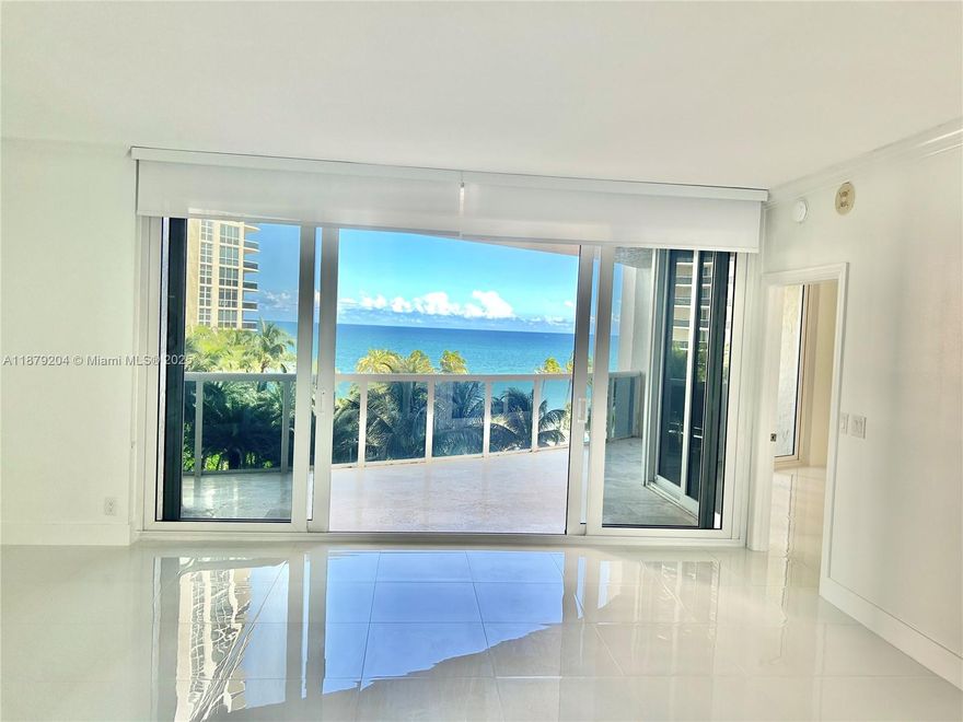 Spectacular ocean and city views! This gorgeous floor through 3 bedroom 2.5 bedroom residence has it all. Floor to ceiling IMPACT glass doors, open floorplan with ocean views, brand new white porcelain floors throughout, beautiful all white kitchen, marble flooring throughout, new powder room, big laundry room with storage, private foyer entry and more. 2 expansive balconies, one with ocean views and the other with city views. 2 garage parking spaces! Additional storage. Endless resort style amenities include pool, fitness center, tennis courts, cafe and valet. 2 dogs allowed. Association has strong reserves, Recent structural and integrity studies completed.