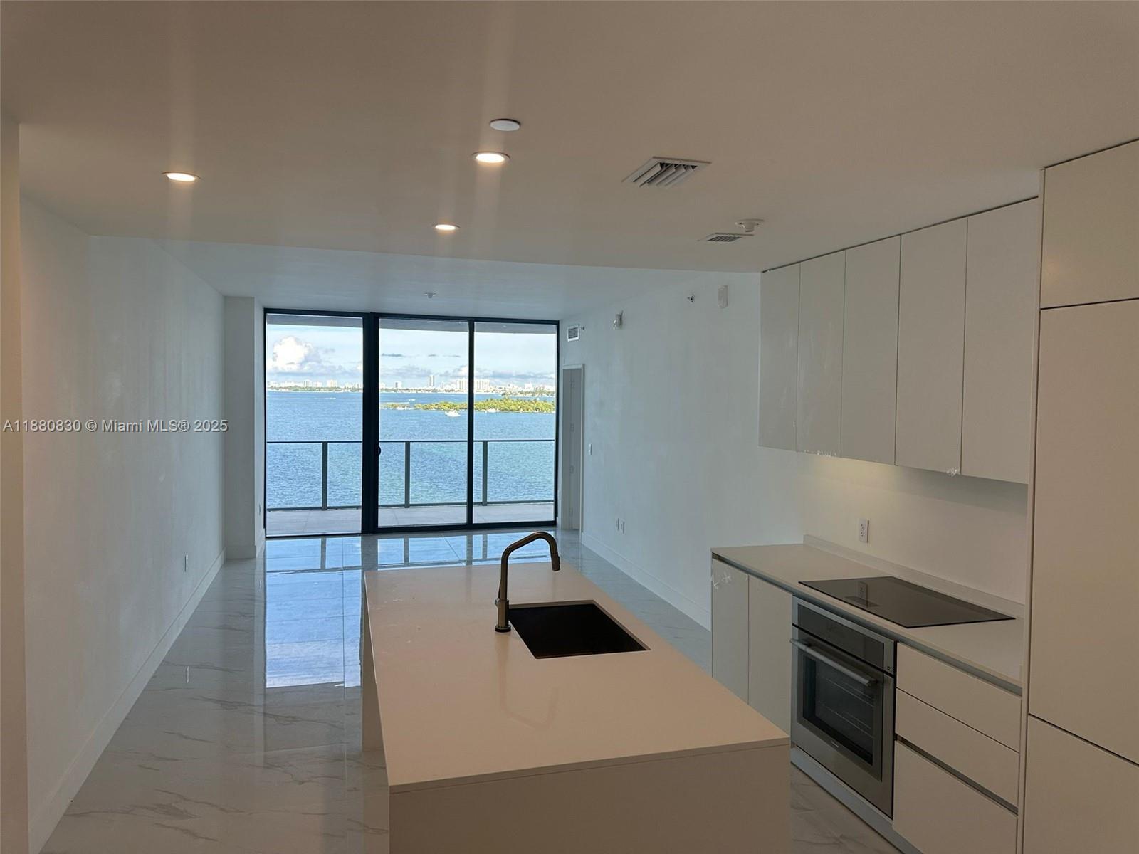 Experience the best of waterfront living at Aria Reserve Miami, Edgewater’s newest luxury address. This never-occupied 1 Bedroom + Den, 2 Bath home features expansive glass walls, modern design, and a private balcony with endless views of Biscayne Bay, Downtown Miami, and Miami Beach. The versatile den offers the perfect space for a home office or guest room. Residents enjoy over 2 acres of lifestyle amenities, including a bayfront park with Baywalk, multiple pools, wellness spa, fitness pavilion, wine lounge, kids’ and game rooms, dog spa, as well as tennis, basketball, pickleball, paddleball, squash, mini golf, and private marina access. Located in the heart of Edgewater, just minutes from Wynwood, the Design District, Brickell, and the beaches.