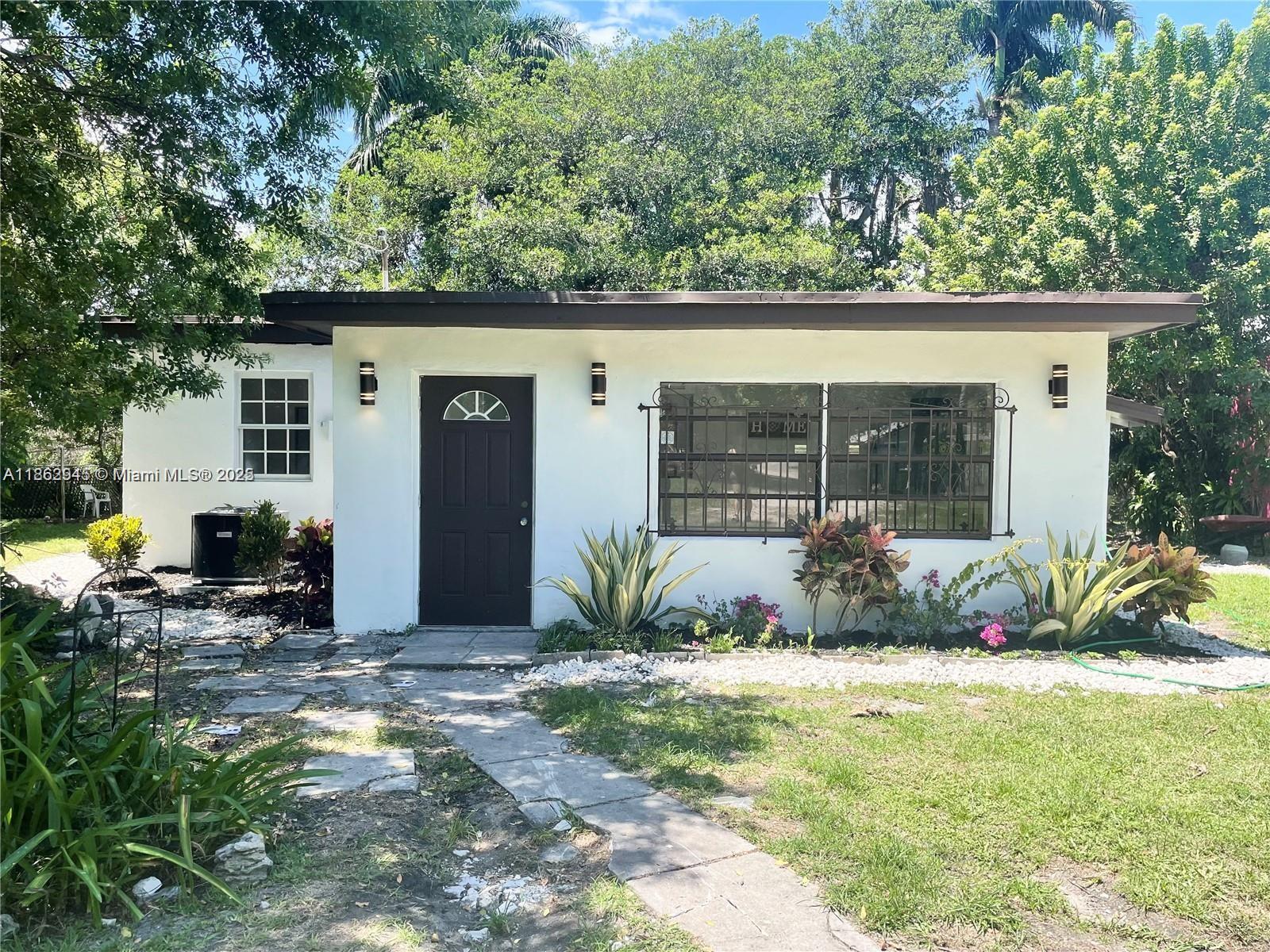 Peaceful remodeled property on a spacious 12,375 sq ft lot with stunning canal views. The main house features 4 bedrooms and 2 bathrooms, along with a detached in-law quarters offering 2 bedrooms and 2 bathrooms, which can be converted into a utility room or rented for extra income. Upgrades include a newer electrical panel, central AC, and updated plumbing. Located on a quiet street in the sought-after West Little River neighborhood, this concrete block home boasts a separate utility room, fenced yard, fruit trees, tile floors, tankless water heater, and a shed for additional storage. The large front yard provides ample parking for boats, trailers, or semi-trucks, while the backyard features a canal and a banyan tree, perfect for entertaining.